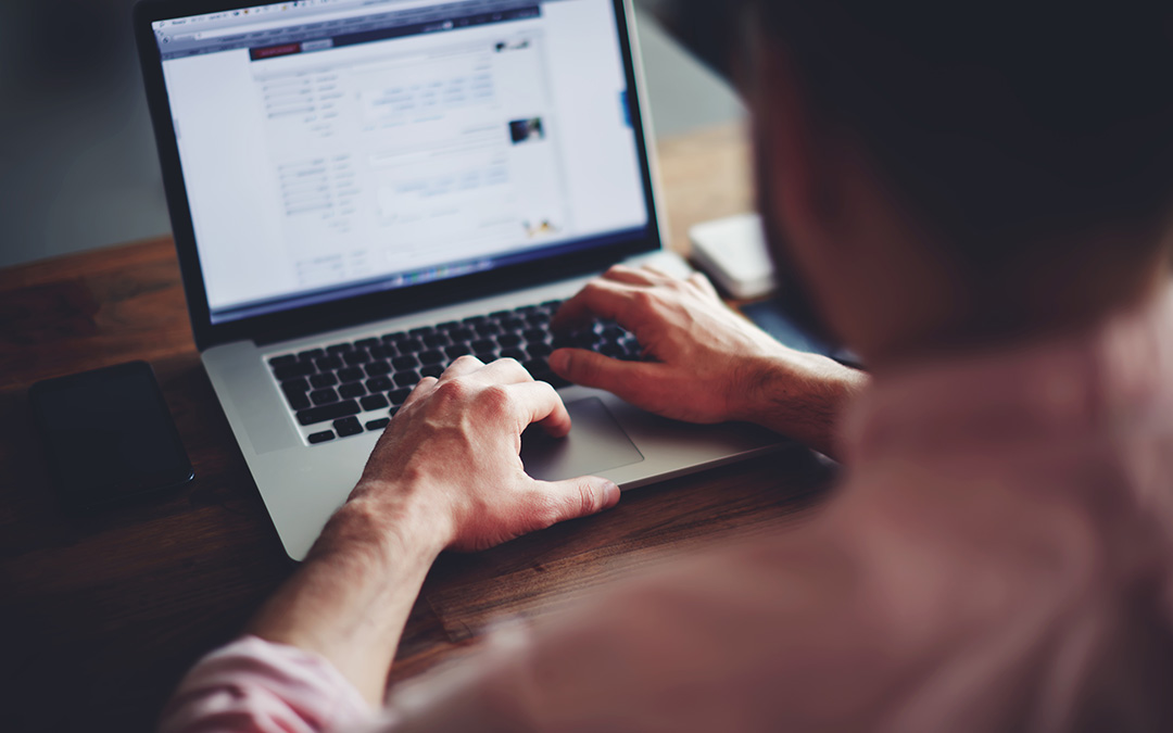 Man working on laptop at table