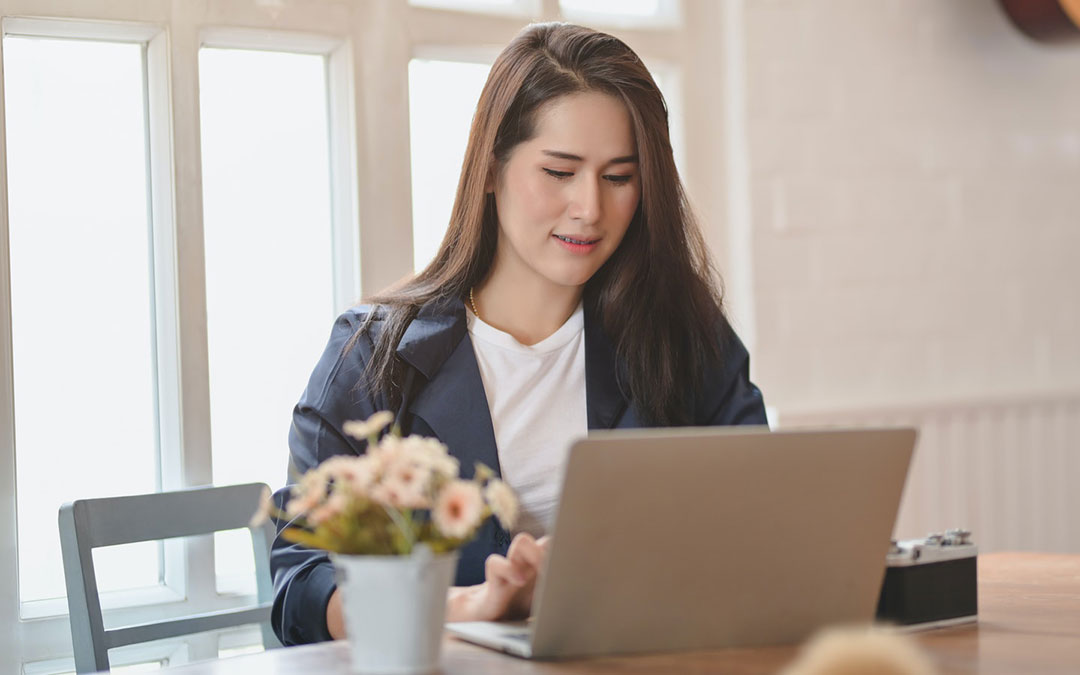 Woman working on computer at table