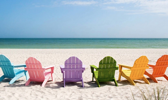 Colorful chairs lined up on beach